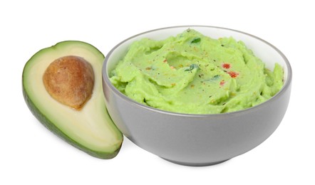 Photo of Bowl of delicious guacamole and fresh avocado isolated on white