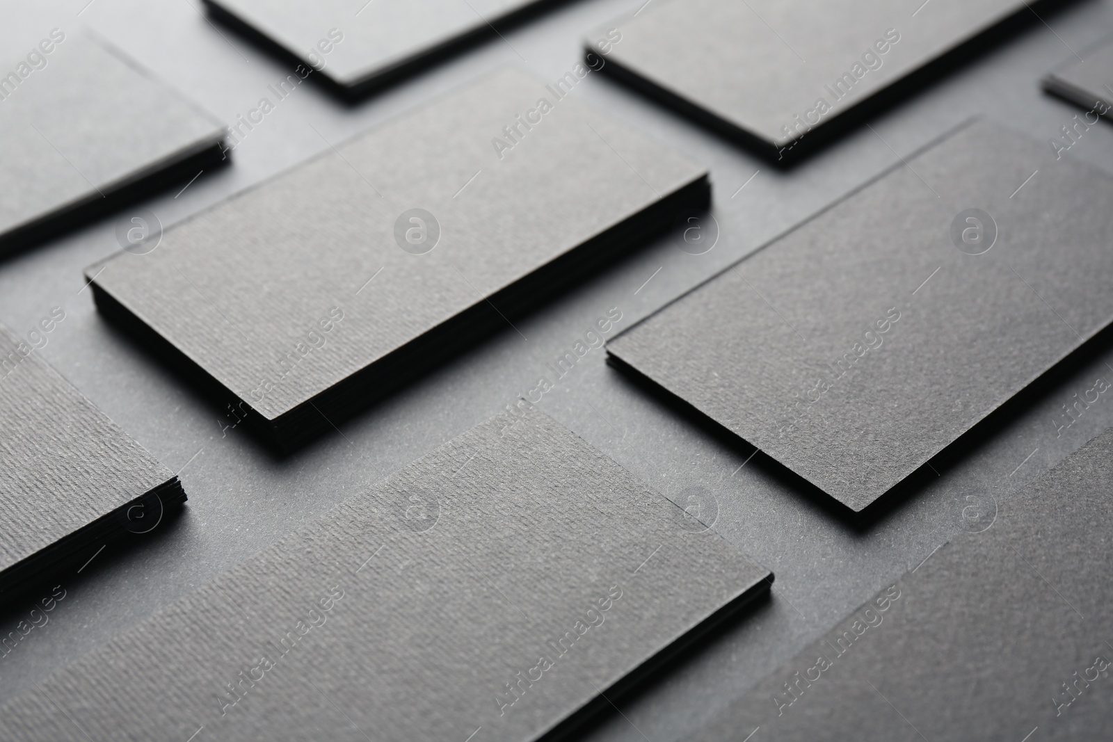 Photo of Blank business cards on black background, closeup. Mockup for design