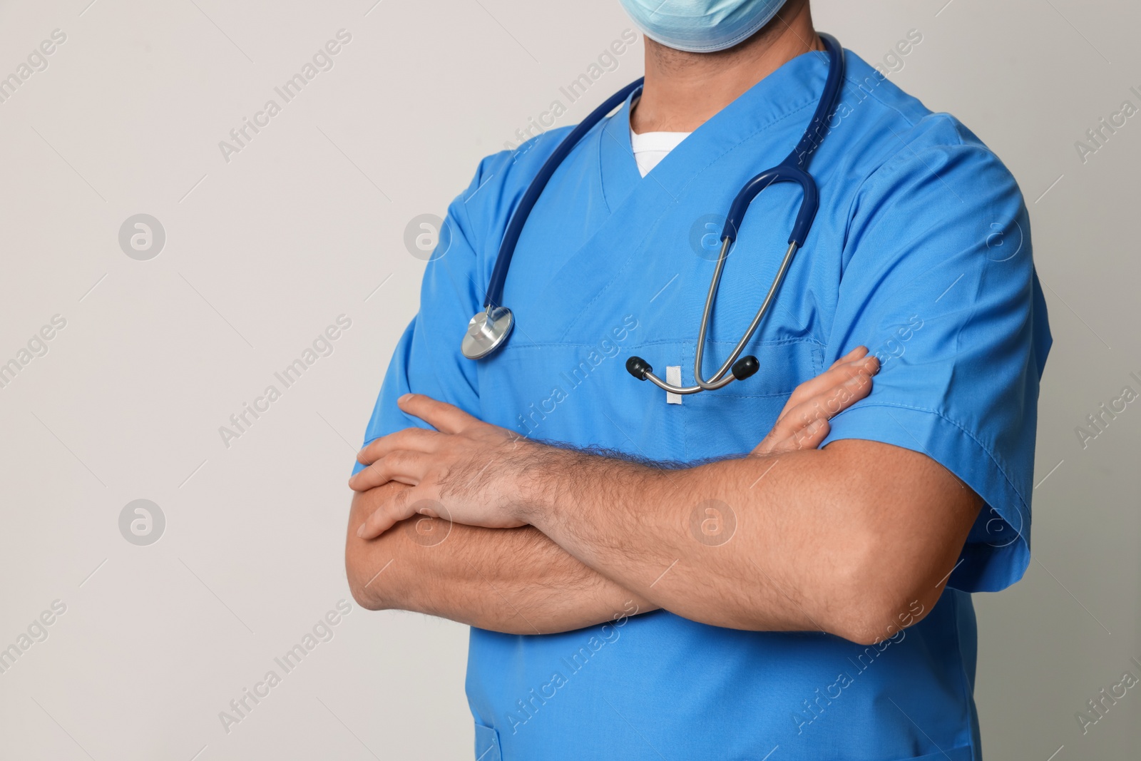 Photo of Nurse in medical uniform with stethoscope on white background, closeup. Space for text