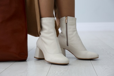 Woman wearing stylish leather shoes indoors, closeup