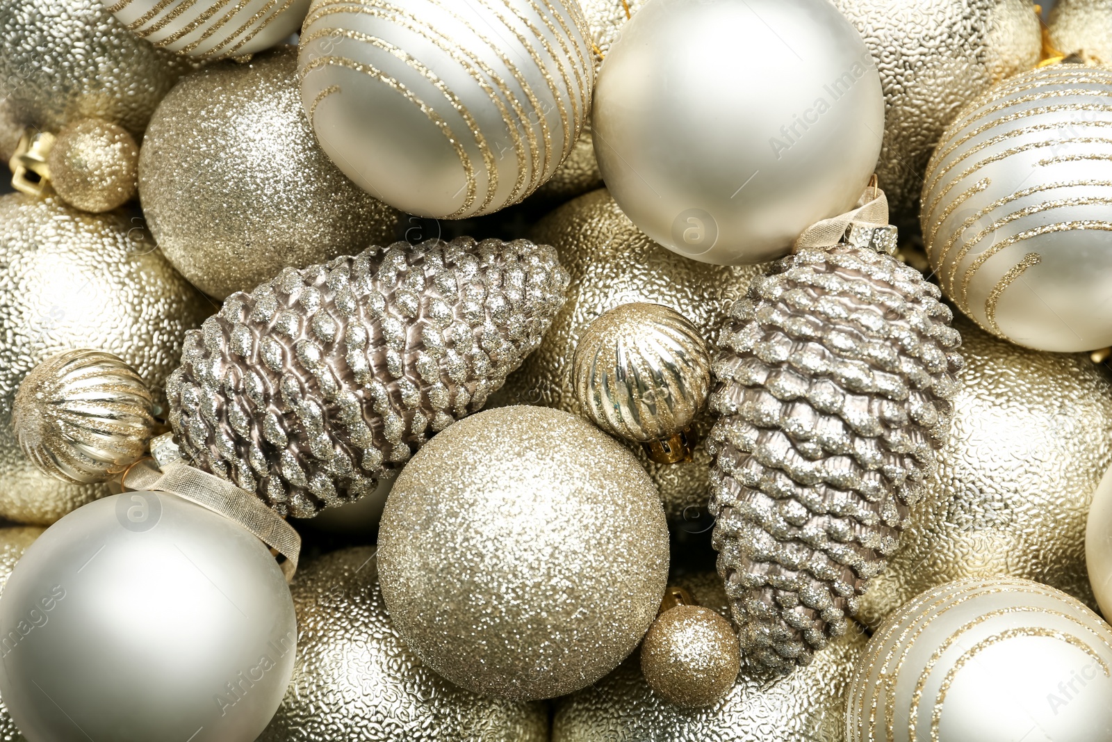 Photo of Beautiful shiny golden Christmas balls as background, top view