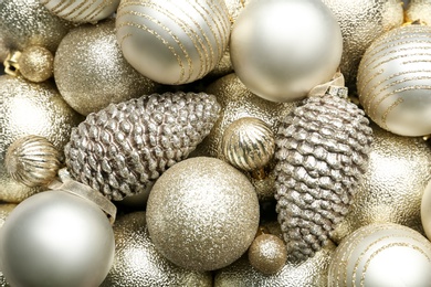 Beautiful shiny golden Christmas balls as background, top view