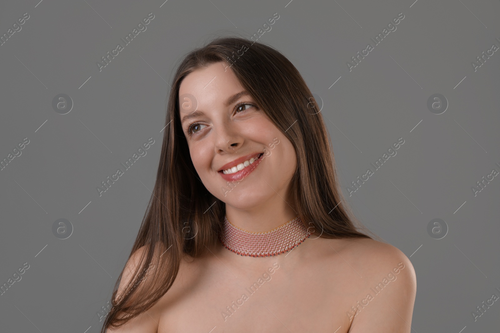 Photo of Portrait of beautiful young woman on grey background