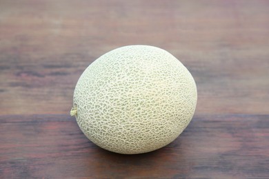 Photo of Whole ripe cantaloupe melon on wooden table