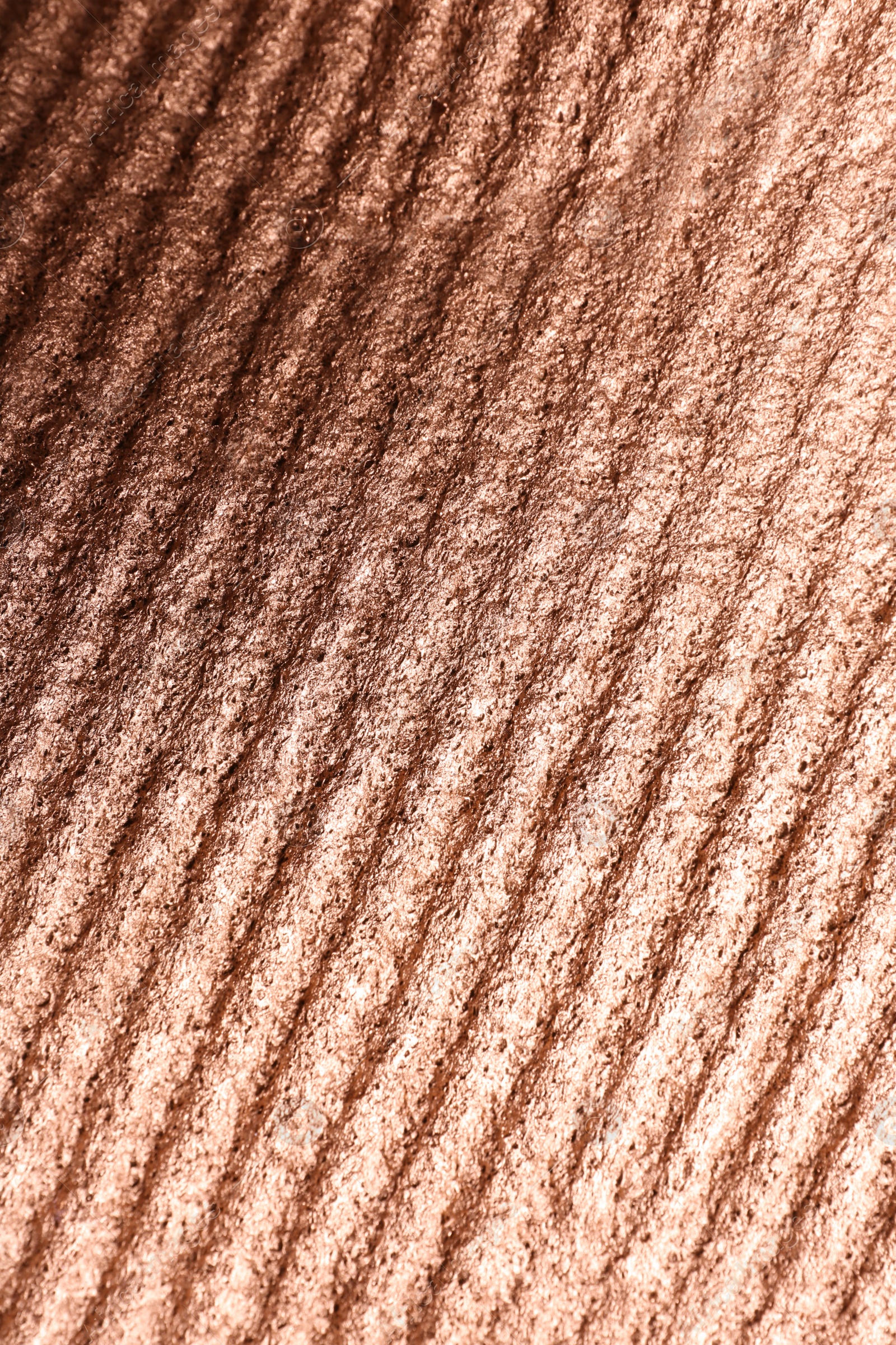 Photo of Corrugated rose gold texture as background, top view