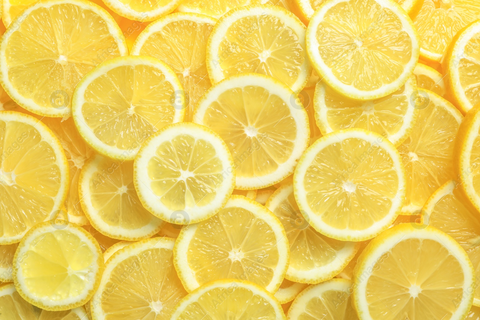 Photo of Many fresh juicy lemon slices as background, top view