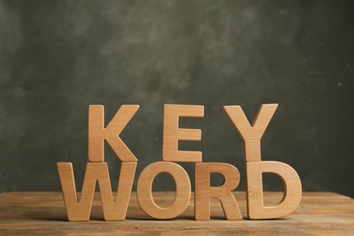 Photo of Word KEYWORD made of wooden letters on table