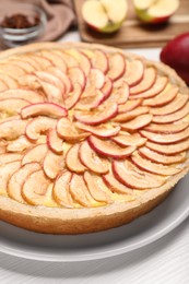 Tasty apple pie on white wooden table, closeup