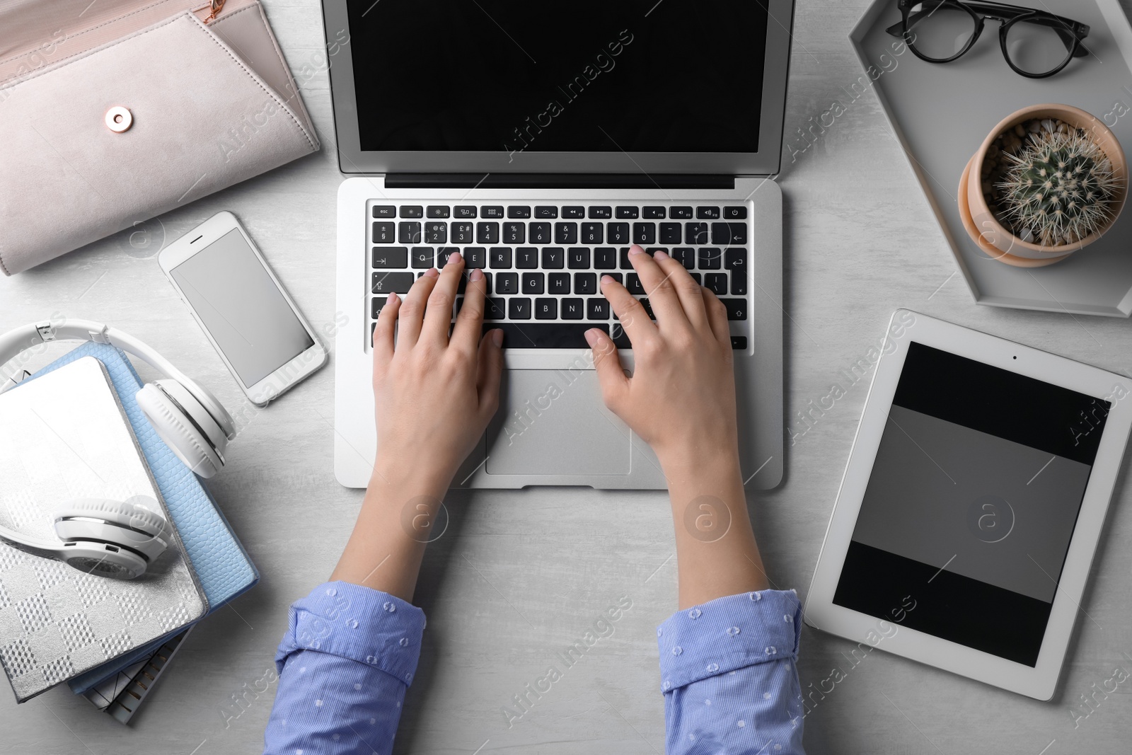 Photo of Blogger typing on laptop at workplace, top view