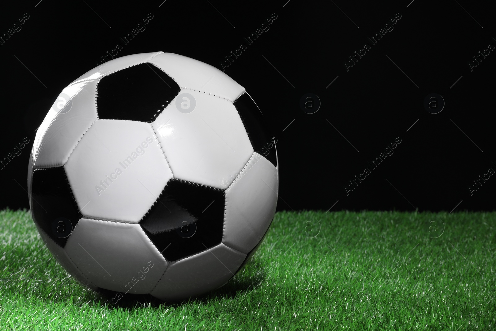 Photo of One soccer ball on green grass, space for text. Sports equipment