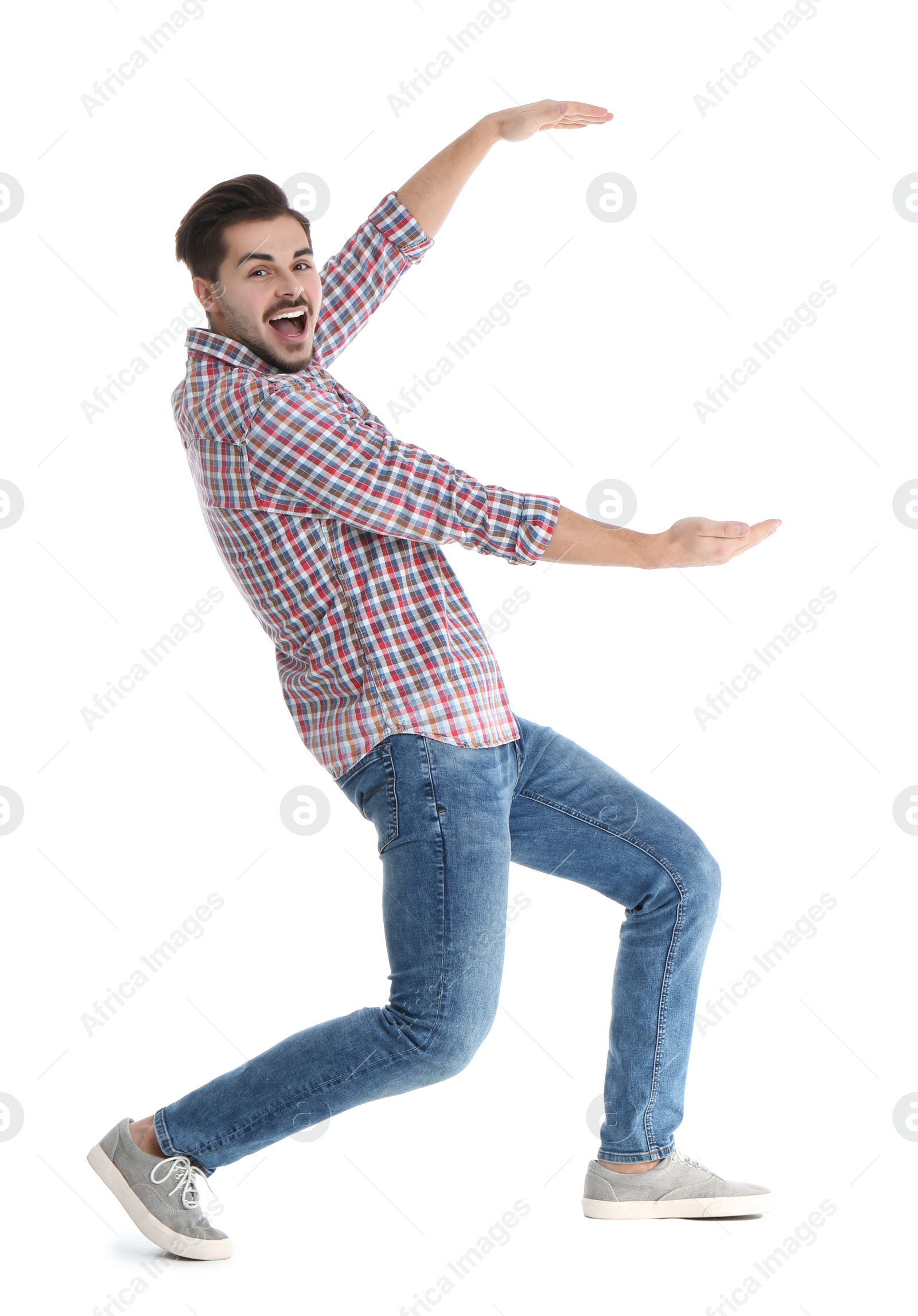 Photo of Young man with magnet attracting people on white background