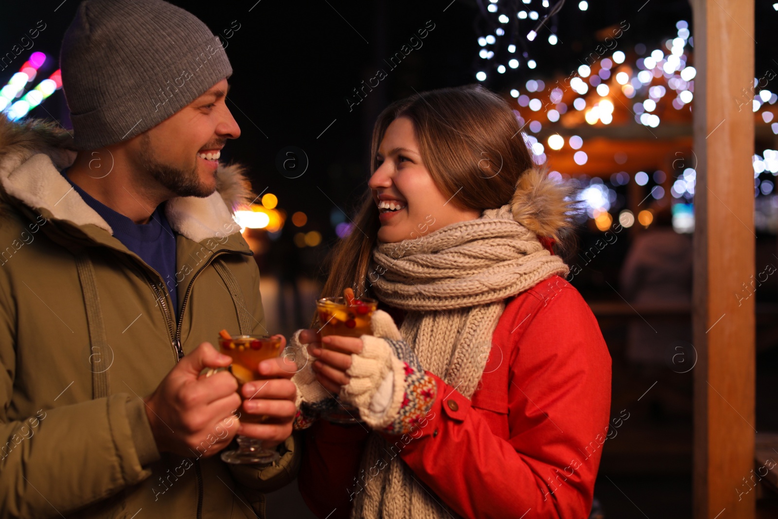 Photo of Happy couple with mulled wine at winter fair