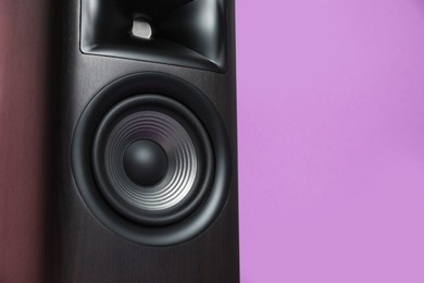 Photo of One wooden sound speaker on color background, closeup. Space for text