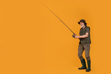 Photo of Fisherman with fishing rod on yellow background, space for text
