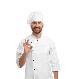 Photo of Mature chef showing ok gesture on white background