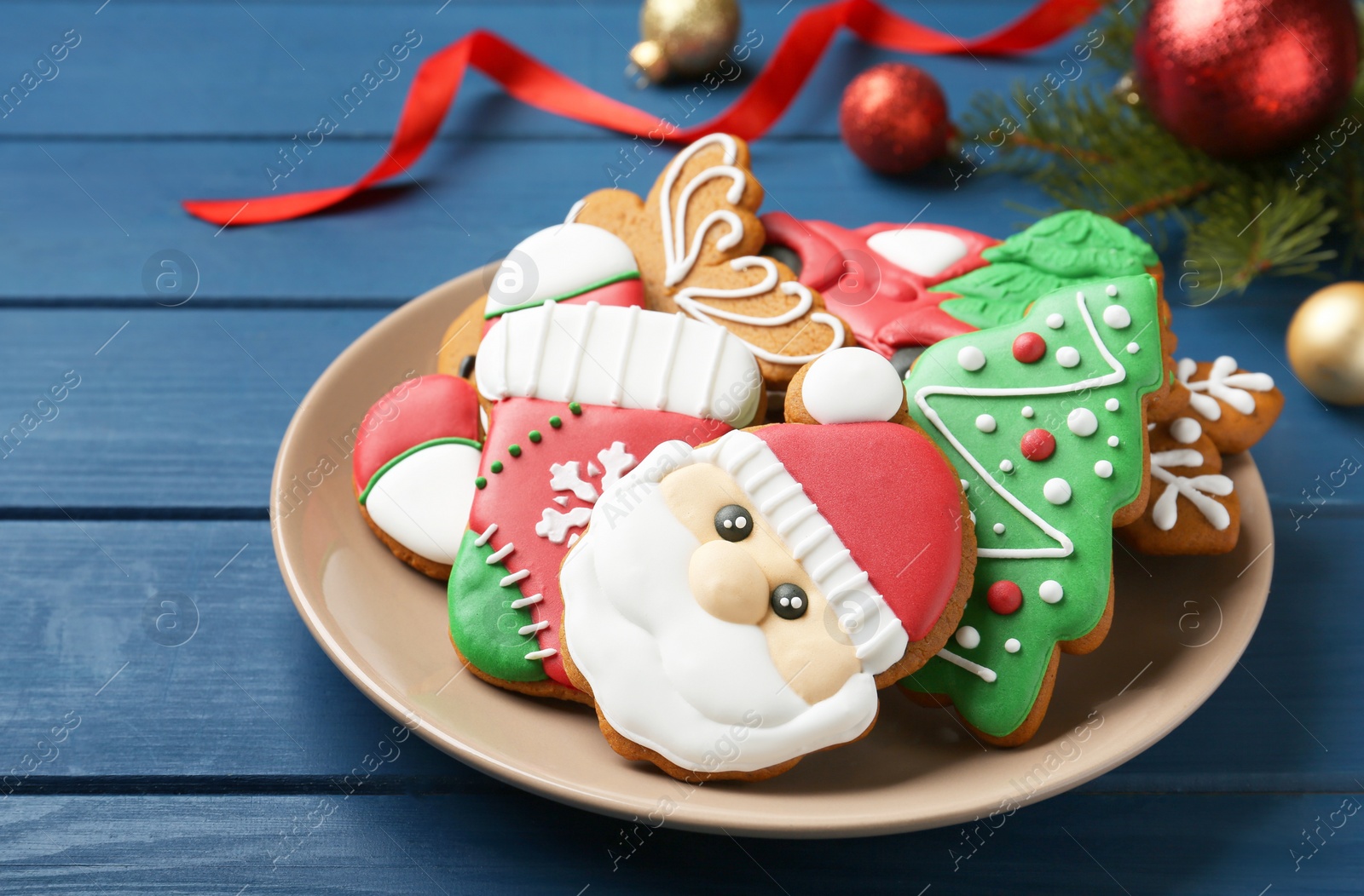 Photo of Different tasty Christmas cookies and decor on blue wooden table, closeup. Space for text