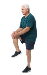 Photo of Full length portrait of senior man having knee problems on white background