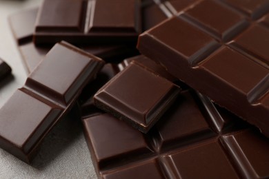 Delicious dark chocolate on grey table, closeup