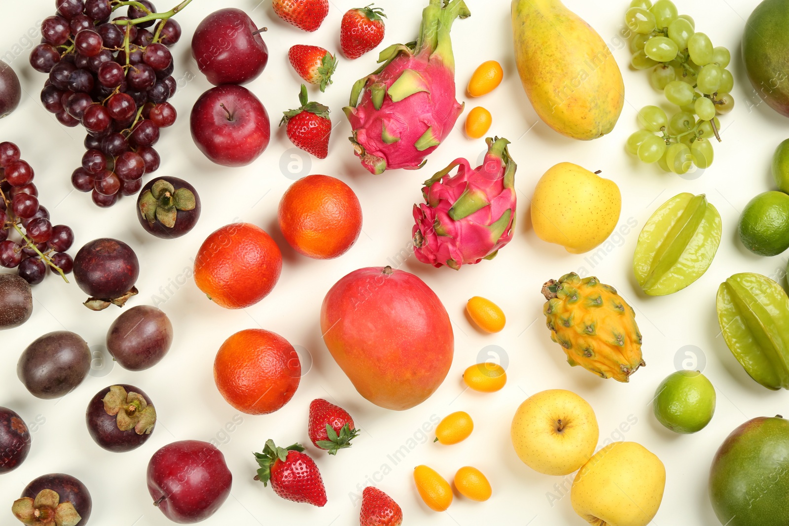 Photo of Assortment of fresh exotic fruits on white background, flat lay