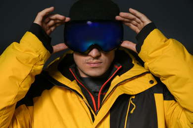 Photo of Man wearing stylish winter sport clothes on black background