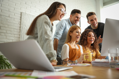 Photo of Team of professional designers working in office