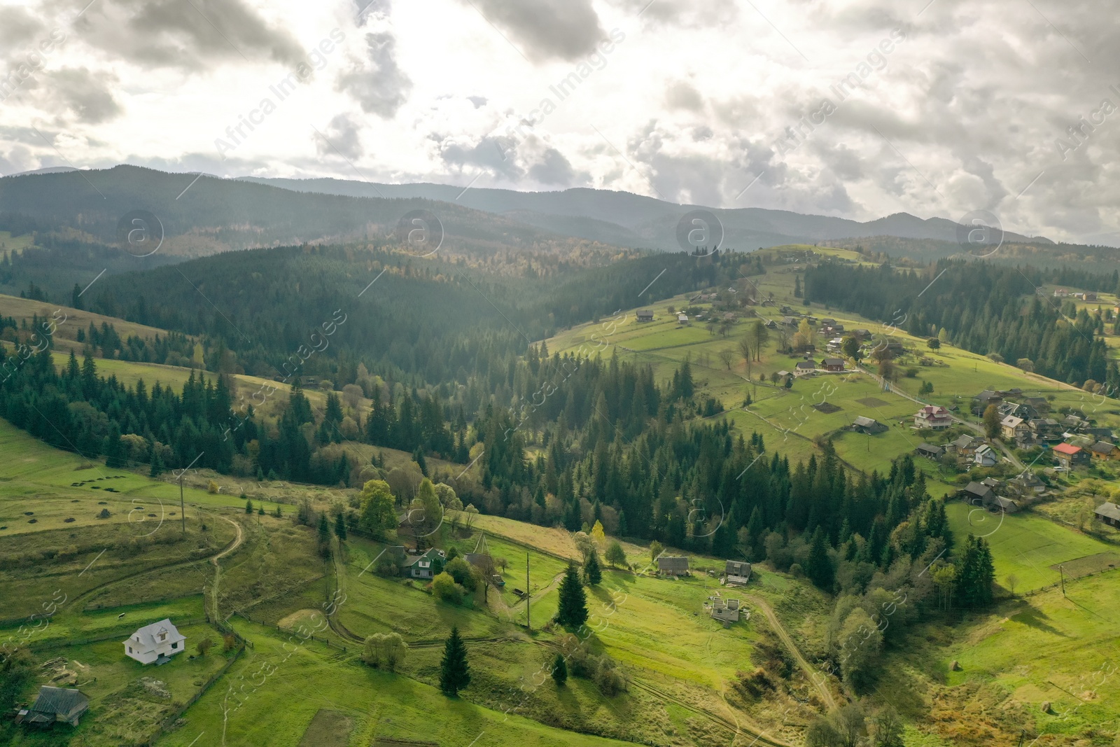 Photo of Aerial view of beautiful forest and mountain village on autumn day