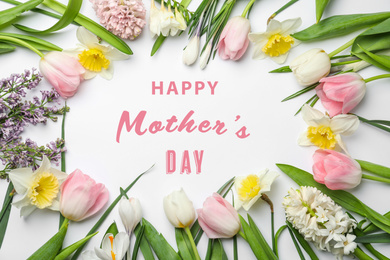 Image of Frame made with beautiful spring flowers and phrase HAPPY MOTHER'S DAY on white background, flat lay