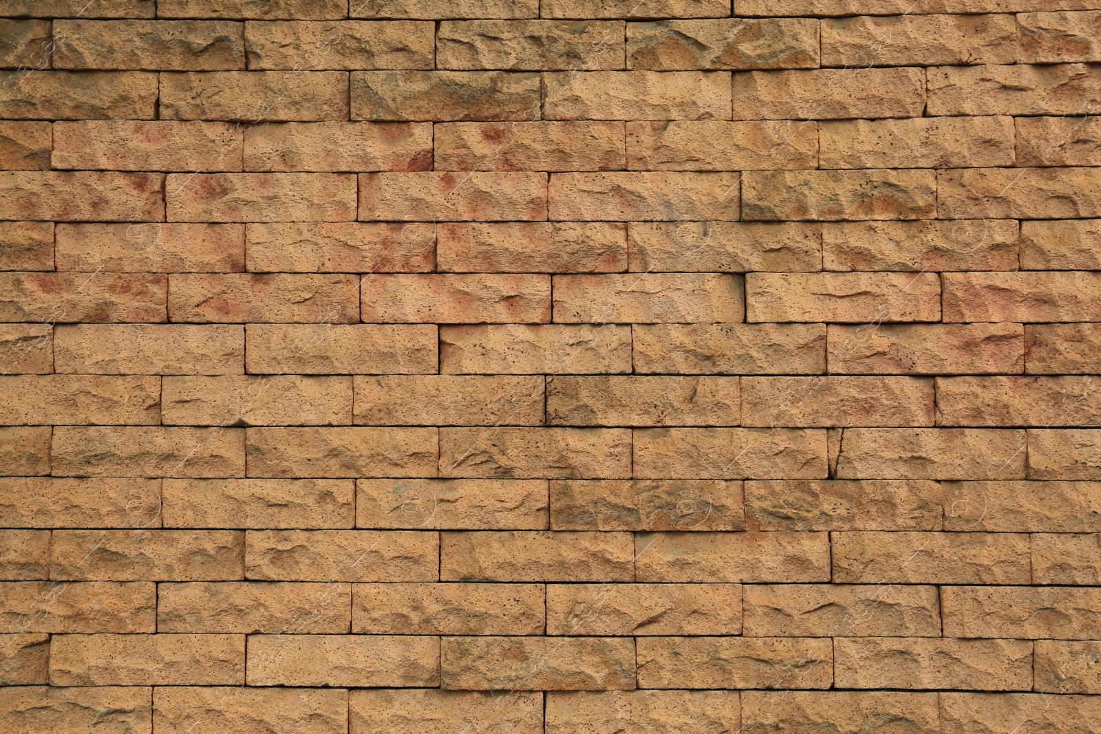 Photo of Beautiful stone wall made of bricks as background, closeup