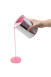 Photo of Woman pouring pink paint from can on white background, closeup