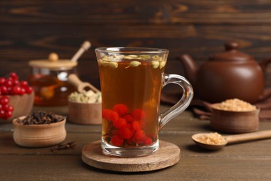 Photo of Tasty immunity boosting drink on wooden table
