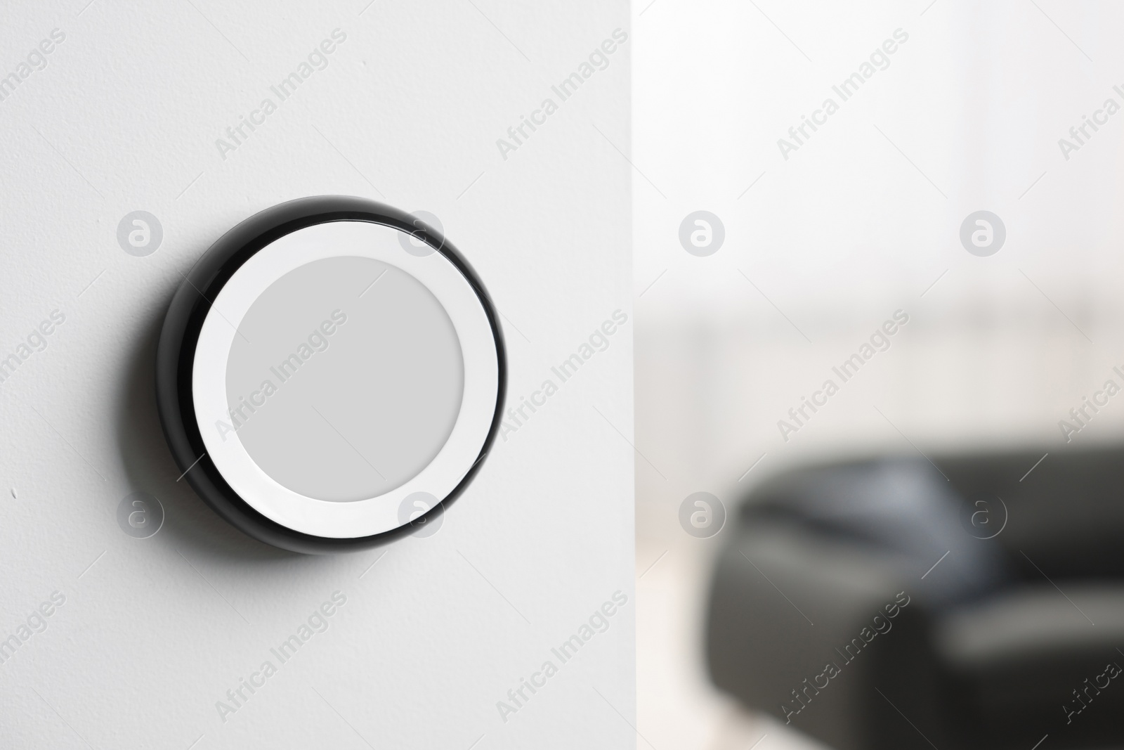 Photo of One thermostat on white wall indoors, space for text. Smart home system