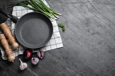 Photo of Flat lay composition with frying pan and fresh products on grey table, space for text