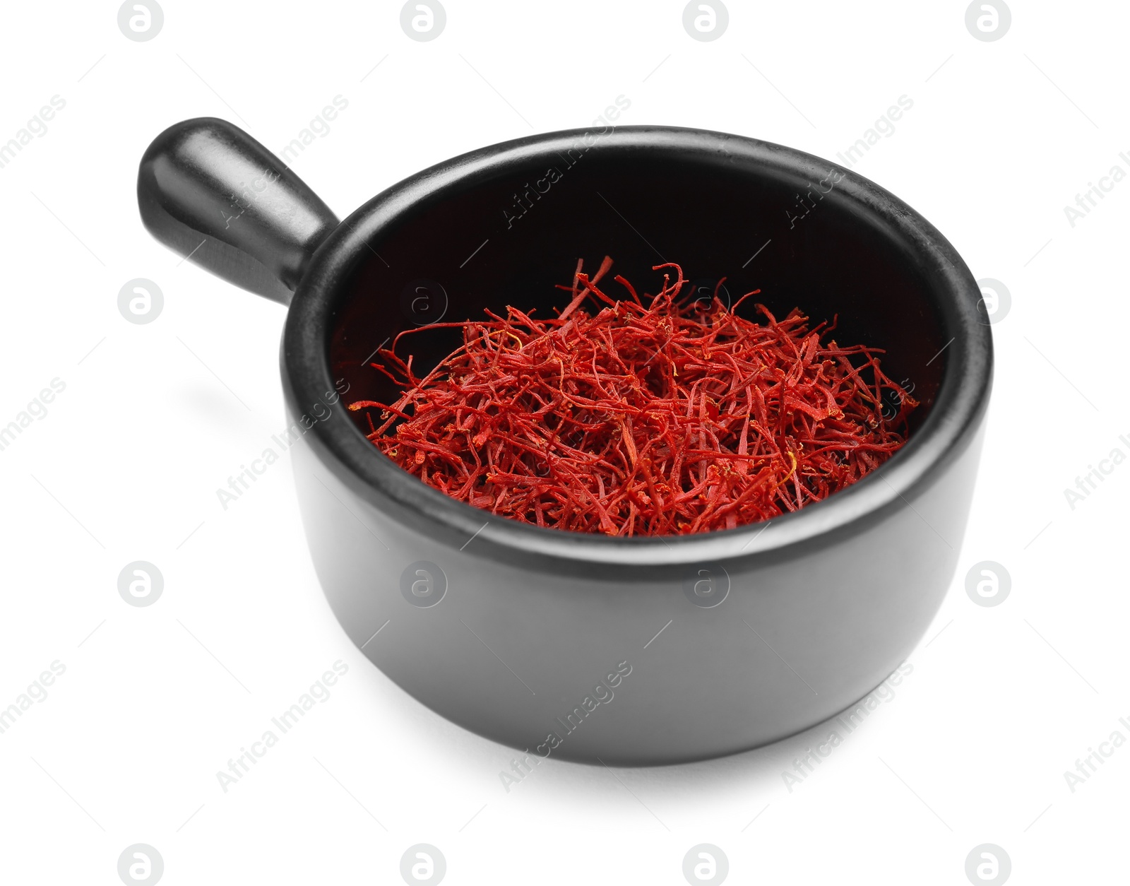 Photo of Aromatic saffron in dish isolated on white