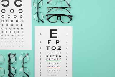 Photo of Vision test chart and glasses on turquoise background, flat lay. Space for text