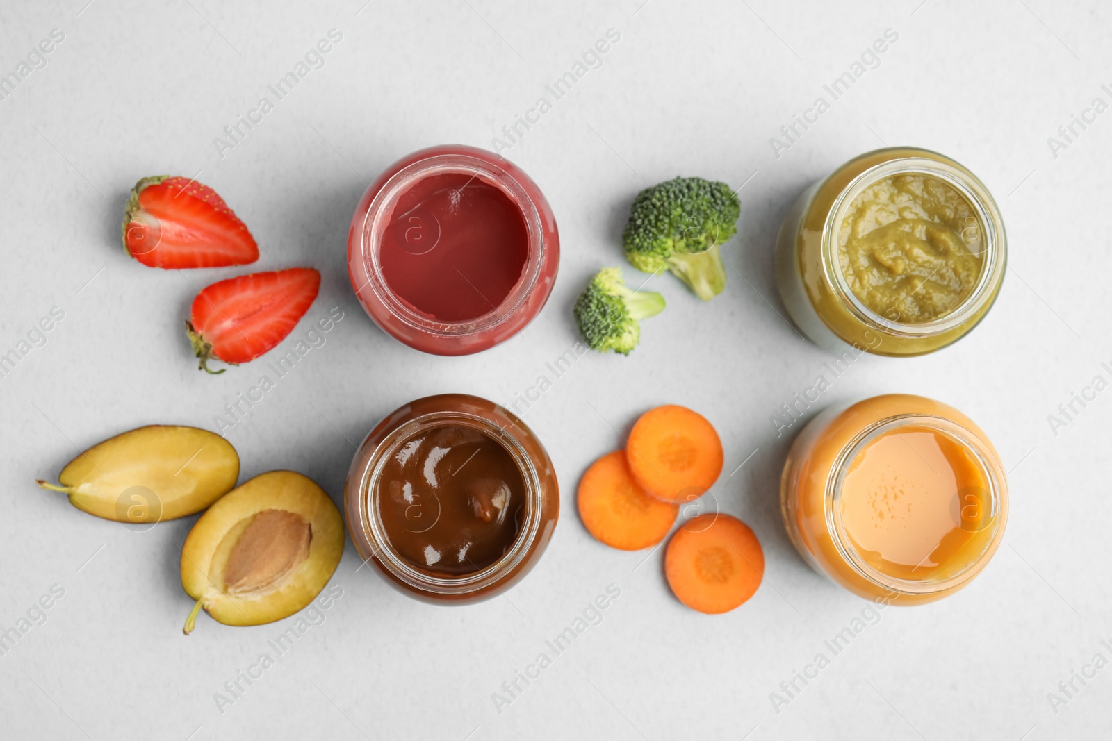 Photo of Flat lay composition with healthy baby food and ingredients on grey background