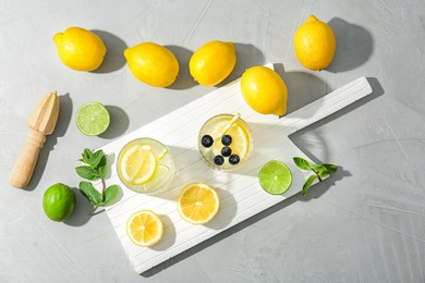 Photo of Flat lay composition with delicious natural lemonade on light background