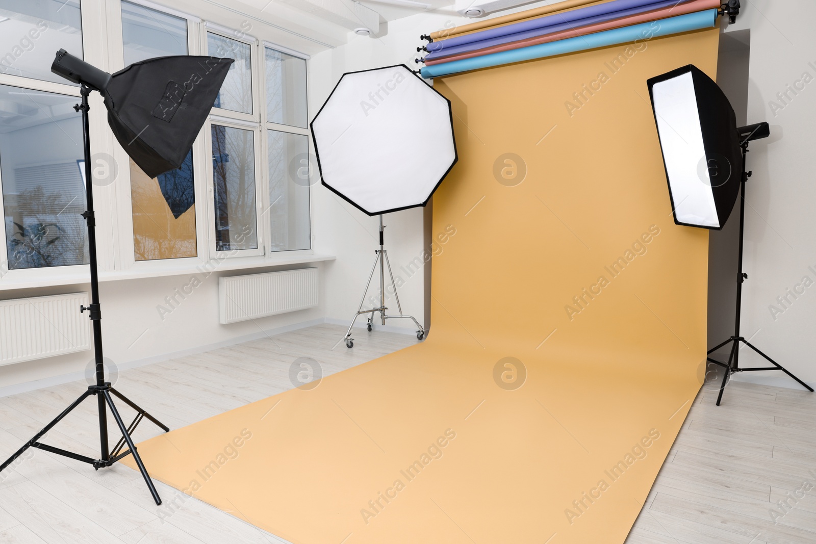 Photo of Interior of modern photo studio with professional lighting equipment