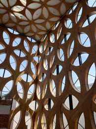 Photo of Decorative wooden pattern covering wall and ceiling in building