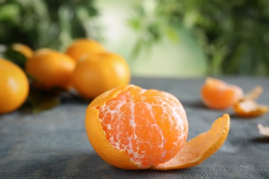 Photo of Fresh tangerine on grey table. Citrus fruit