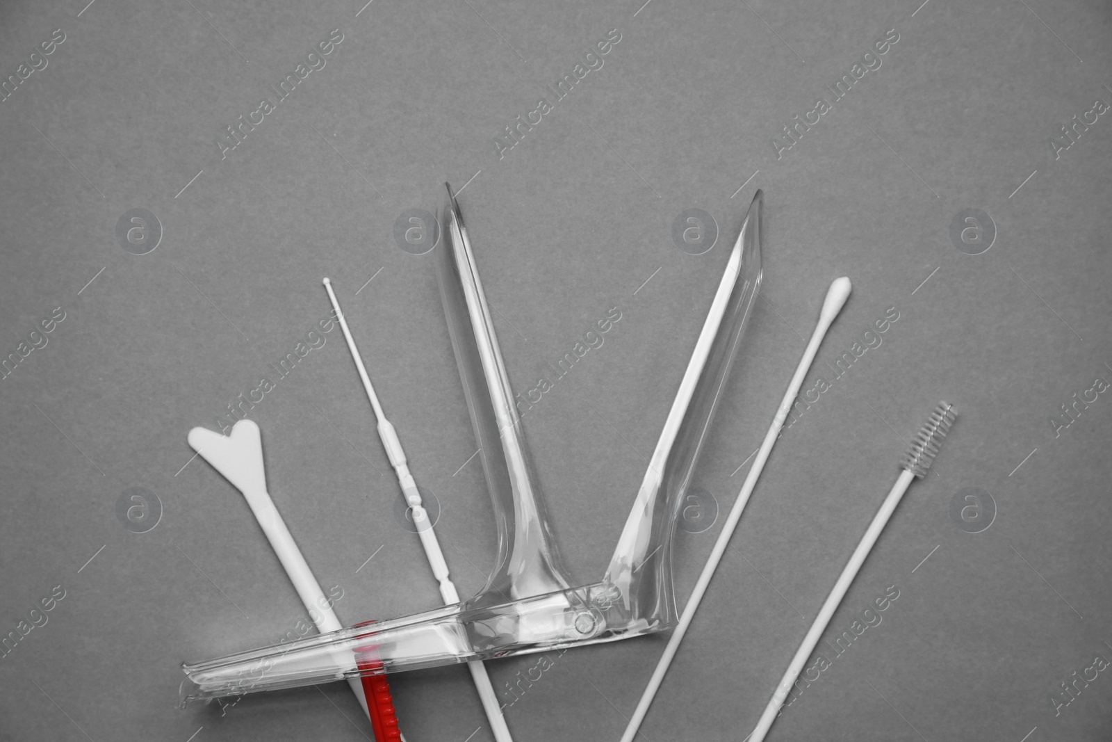 Photo of Sterile gynecological examination kit on grey background, flat lay