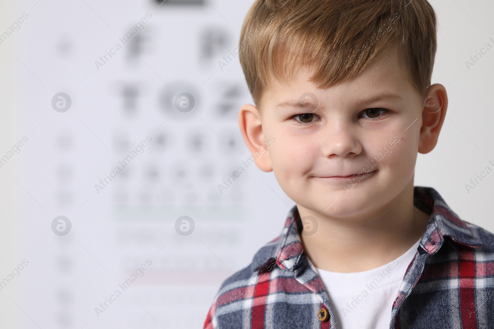 Photo of Portrait of cute little boy on blurred background