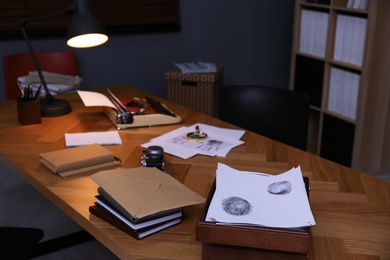 Photo of Typewriter, fingerprints and papers on desk in office. Detective's workplace