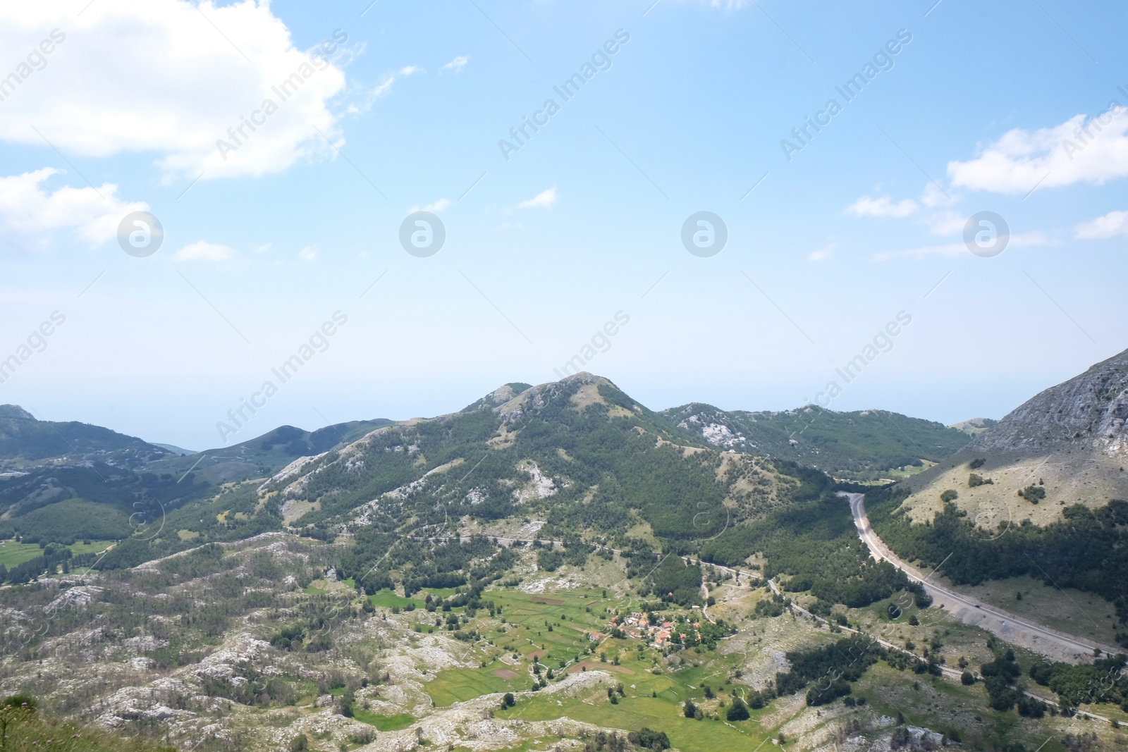 Image of Picturesque view of beautiful mountains under blue sky with clouds