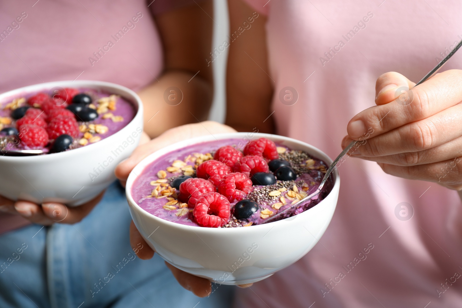 Photo of Women with tasty natural acai smoothie, closeup