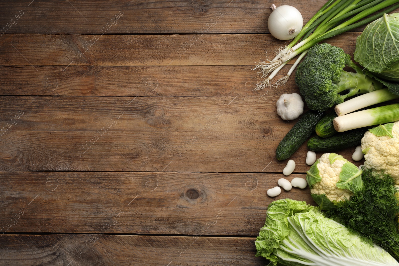 Photo of Different fresh ripe vegetables on wooden table, flat lay. Space for text