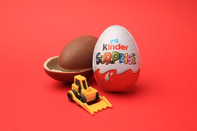 Sveti Vlas, Bulgaria - June 29, 2023: Kinder Surprise Eggs and toy on red background