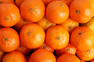 Delicious fresh tangerines as background, top view