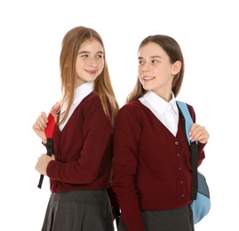 Photo of Portrait of teenage girls in school uniform with backpacks on white background