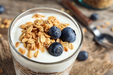 Glass with yogurt, berries and granola, closeup