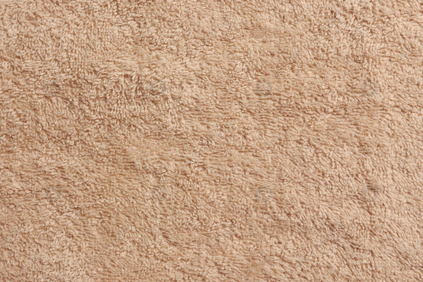 Photo of Soft beige towel as background, top view